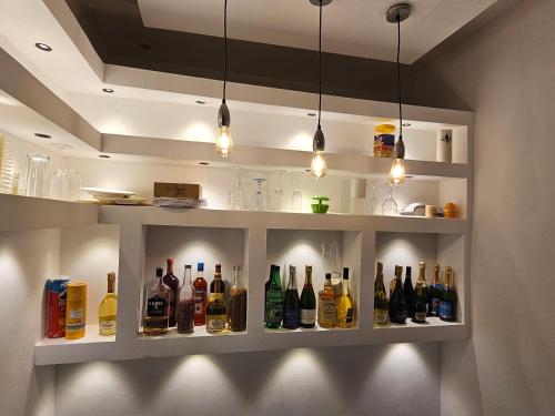 a room with a shelf with bottles of alcohol at Home RÉSIDENCE OUIDAH in Ouidah