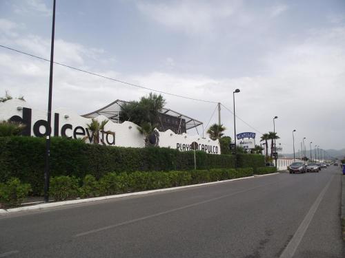 a street with a white building on the side of a road at casa vacanze dei navigatori on the sea in Pontecagnano