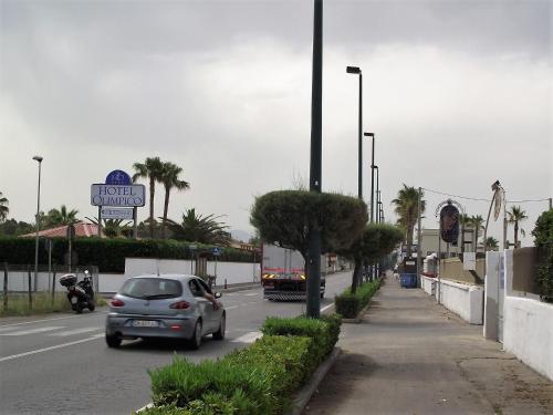 a car driving down a street with a motel sign at casa vacanze dei navigatori on the sea in Pontecagnano