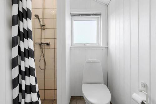 a bathroom with a white toilet and a window at 8106-Ronde-Lindeparken-10 in Rønde