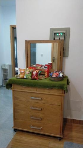 a dresser with a mirror on top of it at Airport Layover Family Lodge in Islamabad