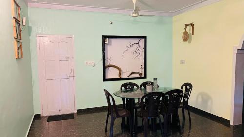 a dining room with a table and chairs at Wild Wood Stays in Madikeri