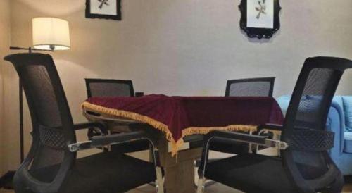 a table with a blanket on it in a room with chairs at Xana Lite Hotelle Yan'an Baota Mountain in Yan'an