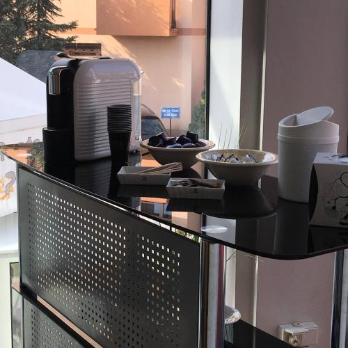 a table with bowls and plates on top of it at Hotel Klein Frankfurt in Frankfurt/Main