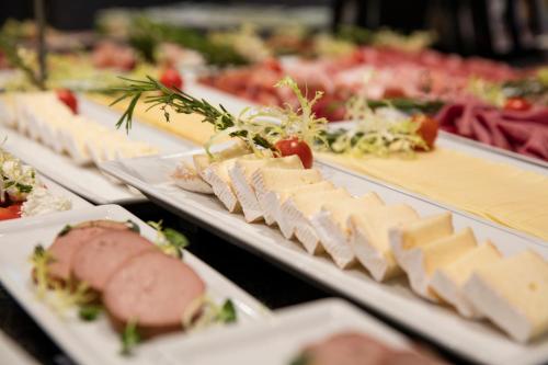 a bunch of different types of food on plates at art'otel berlin mitte, Powered by Radisson Hotels in Berlin