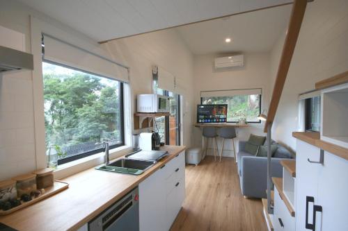 a kitchen and living room of a tiny house at Kookaburra's Perch in Millgrove