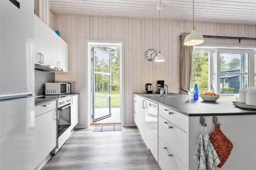 a kitchen with white appliances and a large window at 8245-Knebel-Metholmvej-9 in Knebel