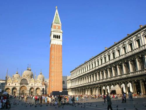 a clock tower in a city with a crowd of people at Pet-Friendly Nature Escape in Pontecchio Polesine