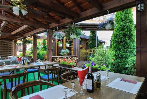 a restaurant with tables and chairs and plants at Grand Częstochowa in Częstochowa