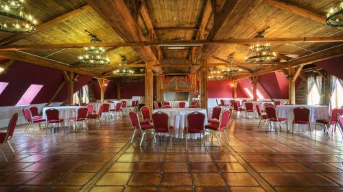 a banquet hall with white tables and red chairs at Grand Częstochowa in Częstochowa