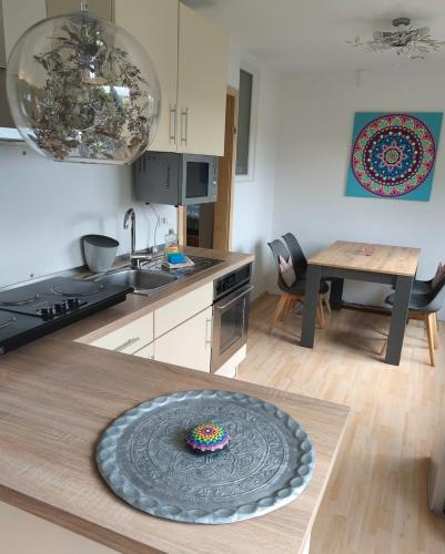 a kitchen with a plate on top of a table at Kleine Auszeit Eifel mit Dachterrasse in Nettersheim