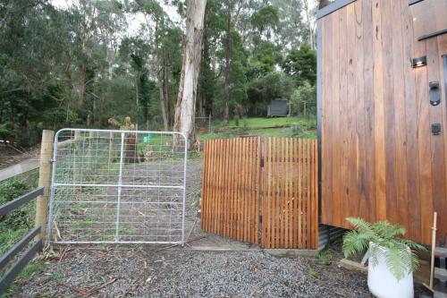 a gate with a fence in front of a building at Kookaburra's Perch in Millgrove
