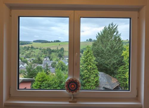 a window with a view of a town at Kleine Auszeit Eifel mit Dachterrasse in Nettersheim
