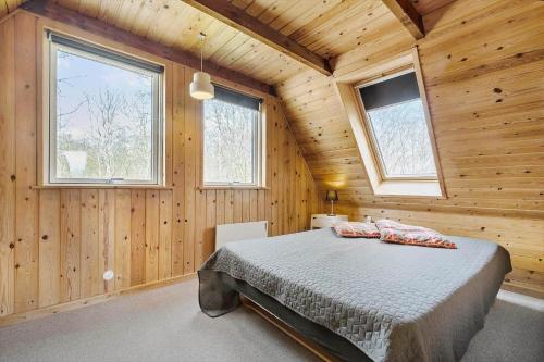 a bedroom with a bed in a wooden cabin at 8004-Knebel-Vestre-Strandvej-19-A in Knebel