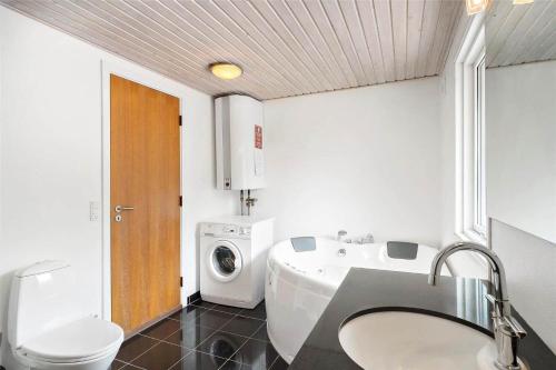 a bathroom with a sink and a washing machine at 8007-Knebel-Soren-Jeppesens-Vej-5 in Knebel