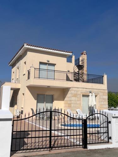 a house with a fence in front of it at Villa Merope Irena 1 in Polis Chrysochous