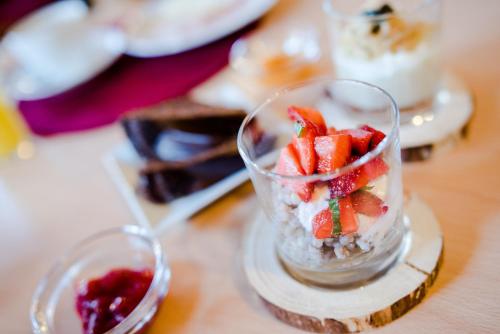 a glass dish with fruit in it on a table at Garni Ortles in Selva di Val Gardena
