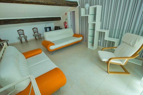a living room with a couch and two chairs at Flor do Mar House in Ponta Delgada
