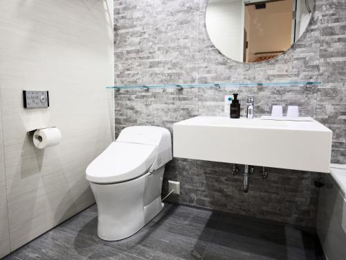 a bathroom with a white toilet and a sink at IN THE LIBRARY hotel and books TOKOROZAWA - Opening in 15th July 2025 in Tokorozawa