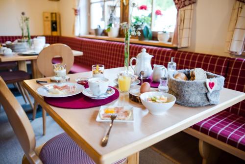 a table with breakfast food on it in a restaurant at Garni Ortles in Selva di Val Gardena