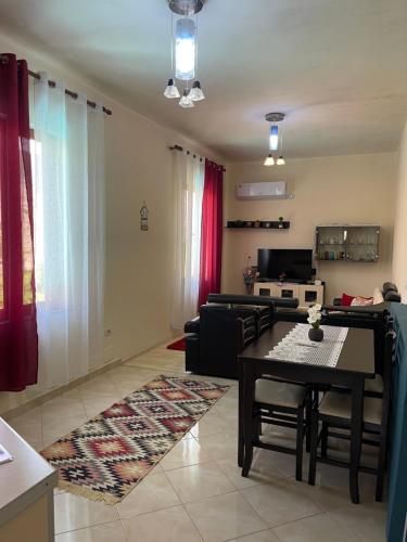 a living room with a table and a couch at Domus Komanesse - Guest Houses in Koman
