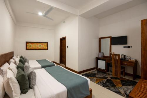 a bedroom with a bed and a desk and a television at 360 Viewpoint by Queens Mount in Kandy