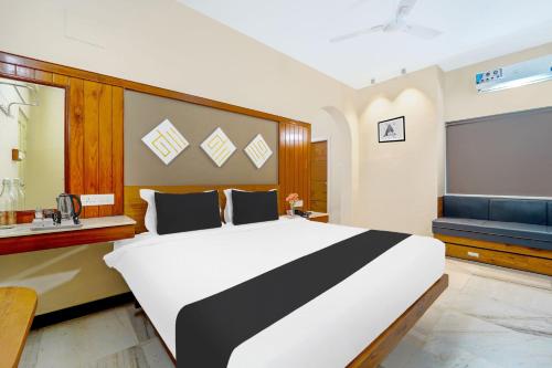 a bedroom with a large white and black bed at Super Hotel O Broadway Ernakulam in Cochin