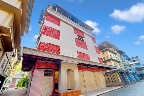 a tall building with red and white paint on it at Super Hotel O Broadway Ernakulam in Cochin