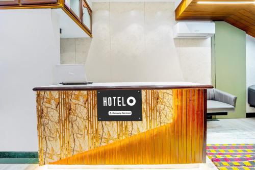 a reception desk with a laptop on top of it at Super Hotel O Broadway Ernakulam in Cochin