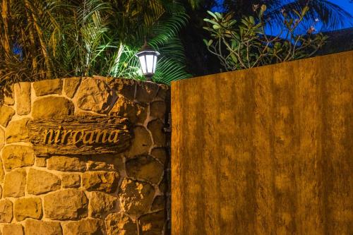 a stone wall with a light on top of it at Nirvana Luxurious Pool Garden Villa in Vasai in Vasai