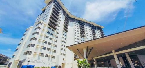 a large white building in front of a building at Stena Stays in Kaybagal