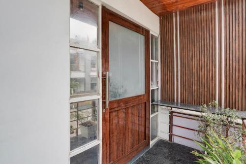 an entrance to a house with a wooden door at Super Townhouse Oak Arvindo Park Indira Nagar Formerly Rama Inn in Vibhuti Khand