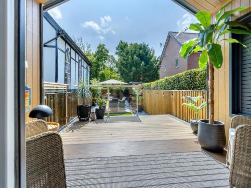 a patio with chairs and a wooden deck at Aqueduct Hideaway in Llangollen