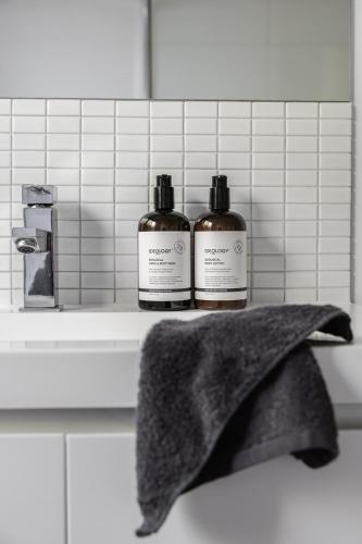 two bottles of soap on a shelf in a bathroom at The Willows Coastal Retreat in Old Ocean Grove in Ocean Grove