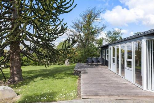 a wooden walkway leading to a house with a garden at 8442-Ronde-Lindeparken-56 in Rønde