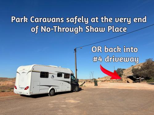 a white truck parked in a parking lot at Ali's Underground Home in Coober Pedy