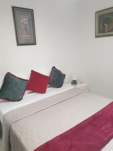 a bed with three pillows on top of it at Chermakish Exceptional View Logement 3 Chambres, Piscine in Marigot