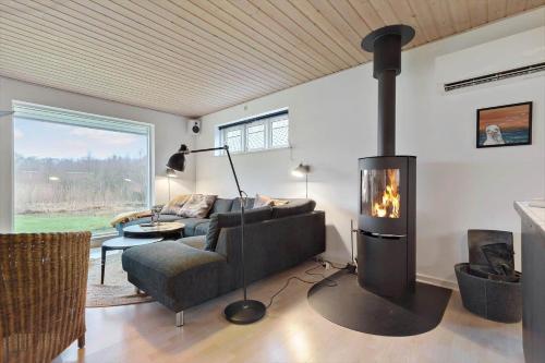 a living room with a couch and a fireplace at 84231-Ebeltoft-Magevej-50 in Ebeltoft
