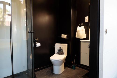 a bathroom with a white toilet and a sink at SEE - Gare de Marly in Valenciennes