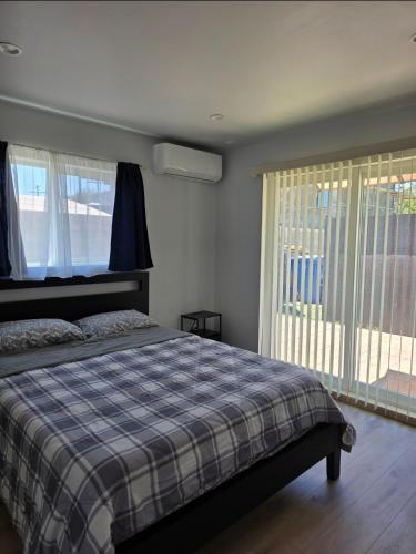 a bedroom with a bed and a large window at Casa One in Winnetka