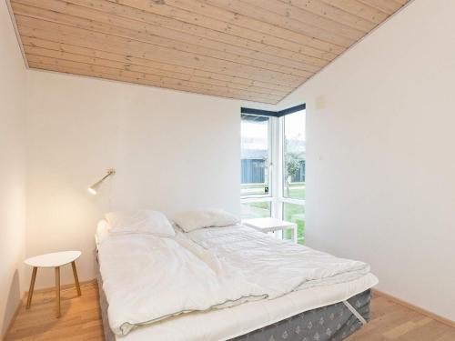 a bedroom with a bed and a window at Scenic Golf Retreat-By Traum in Bogense
