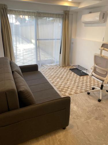 a living room with a couch and a chair at Guest suite in Brighton in Melbourne