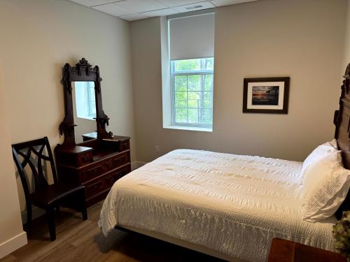 a bedroom with a bed and a mirror and a dresser at Burk's Fall River View 2b2b in Burks Falls