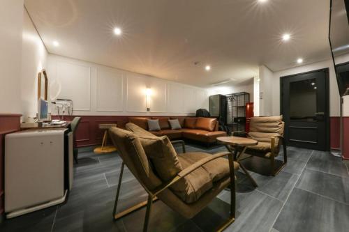 a living room with a couch and a table at Cheongju Maryjane Hotel in Cheongju