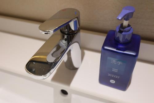 a bathroom sink with a faucet and a bottle of toothpaste at Hanting Hotel Beijing South Railway Station Center in Beijing