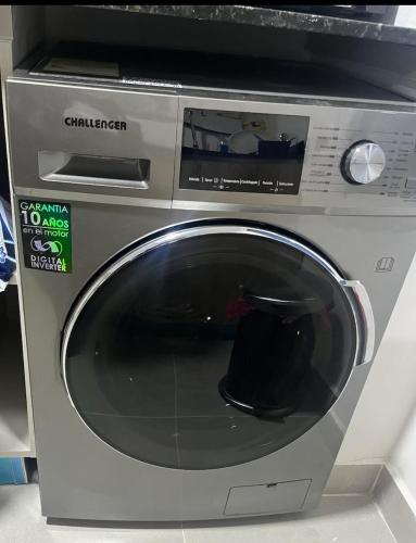 a washing machine with a black hat on top of it at Cozy Spot Condo in Punta Cana