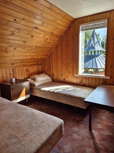 a room with two beds and a window at Basanavičiaus kambarelis in Palanga