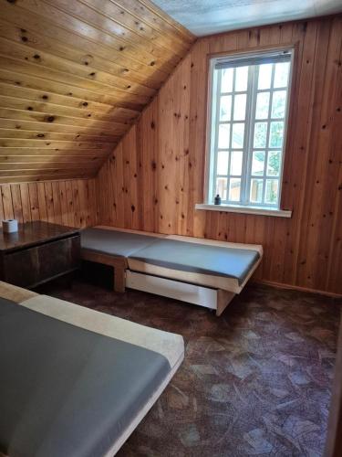a large room with a bed and a window at Basanavičiaus kambarelis in Palanga