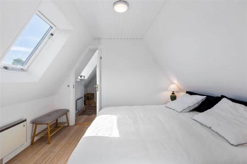 a white bedroom with a bed and a window at 1319-N-Liseleje-Liselejevej-55 in Liseleje