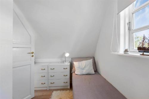 a small bedroom with a bed and a window at 1319-N-Liseleje-Liselejevej-55 in Liseleje